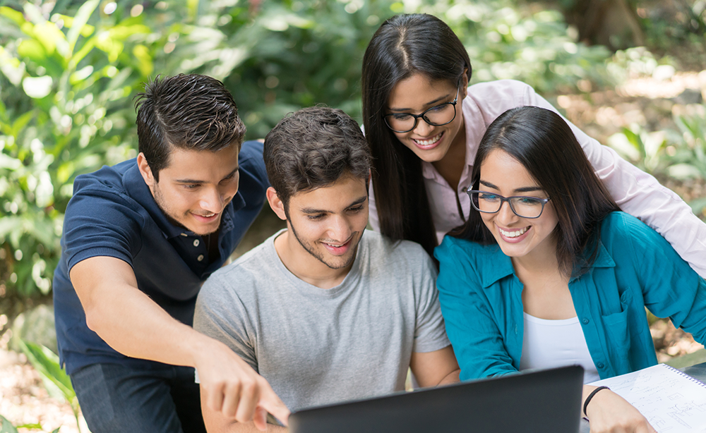 EDU-Students-Smiling-Looking-at-Laptop-Outside-TY