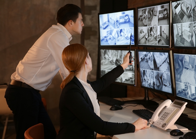 male-female-monitoring-CCTV-screens