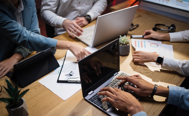 business-team-office-studying-documents-laptops business-team-office-studying-documents-laptops