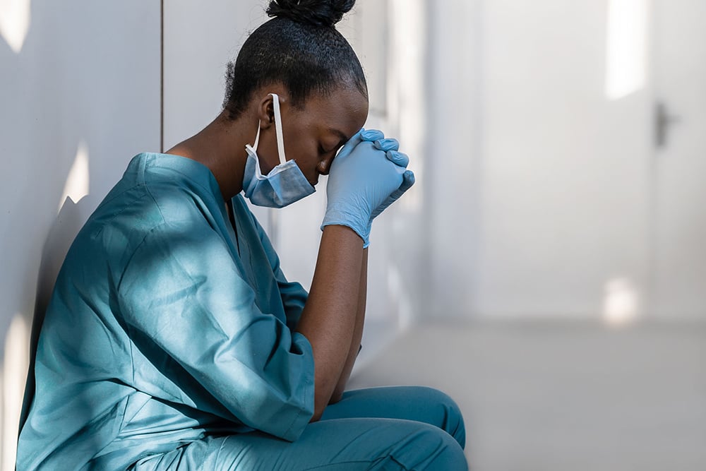 female-nurse-in-scrubs-meditating-intensely